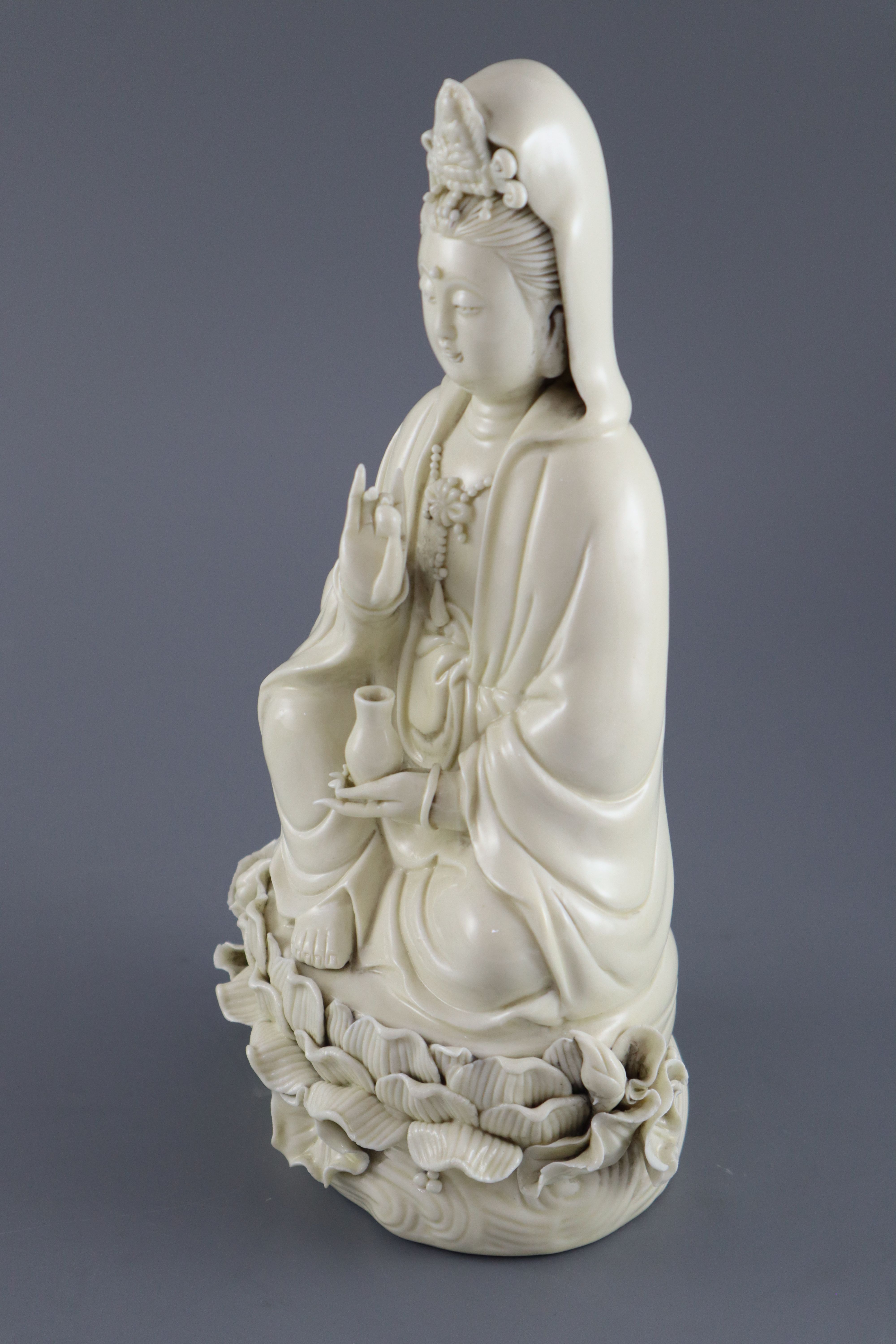 A Chinese Dehua blanc de chine figure of Guanyin, impressed seal to back, 26.5cm high
